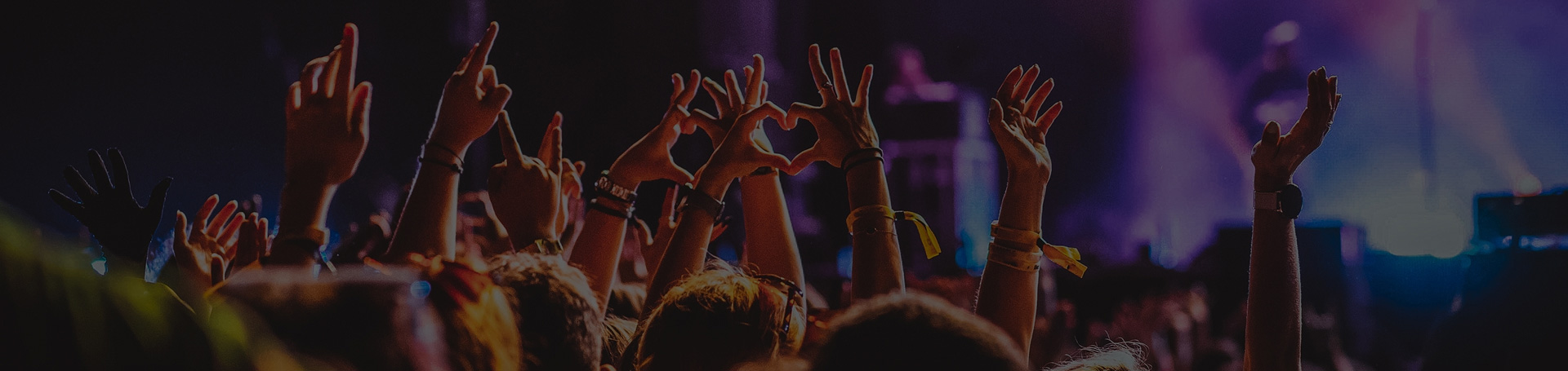 Crowd participating in technology event with raised hands