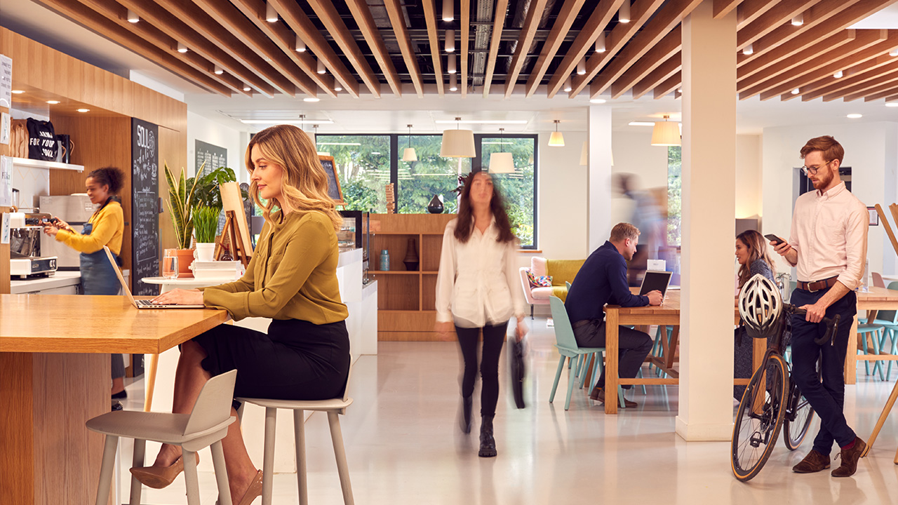 Modern, collaborative office space with professionals working in a relaxed and dynamic environment, illustrating the importance of aligning software modernization with company culture.